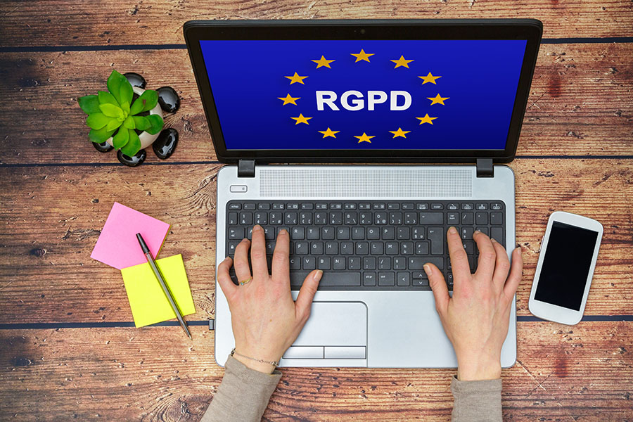 Woman using a computer with Flag of European Union with RGPD word inside on the screen